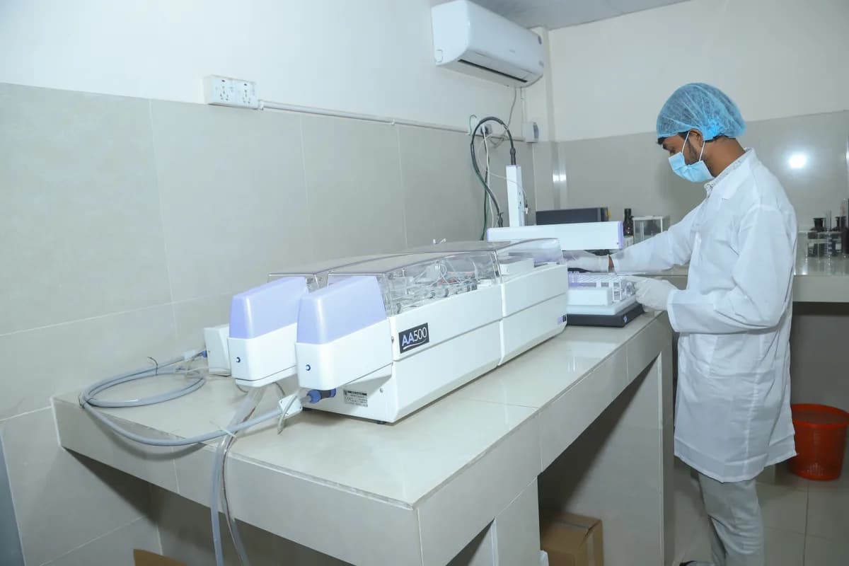 GLTCL laboratory analyst testing tobacco samples on an AA500 auto-analyzer